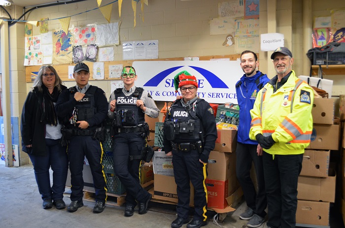 Group photo of Coquitlam RCMP dropping off donations to the SHARE Society