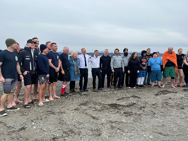 Photo of 2023 Surrey Polar Plunge participants posing for a picture together at the beach