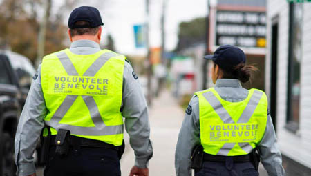 Two auxiliairies walking in vests