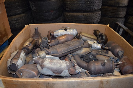 Catalytic converters piled in a box indoors