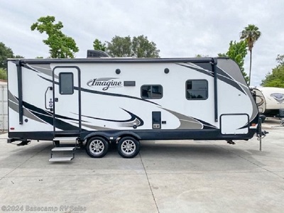 White Imagine Grand Design recreational trailer with closed awning and stairs 