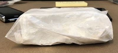 Partial brick of suspected cocaine seized by SGET