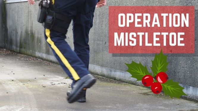 a police officer walking with the words "operation mistletoe" displayed