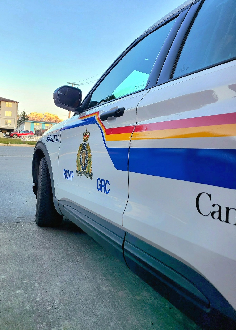 Port Alberni RCMP vehicle with RCMP graphic on the door. Mount Arrowsmith is in the distant background.