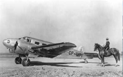 Old plane with officer on horse beside it