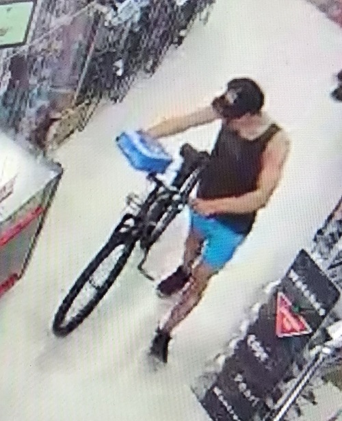 surveillance photo of suspect stealing bike