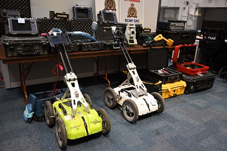 Heavy duty specialized equipment laid out on the floor and on a table. 