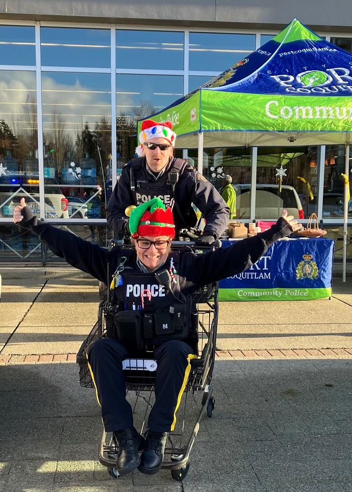 Cpl. Bauer pushed Cst. Mitchell in shopping cart while accepting donations for Cram the Cruiser