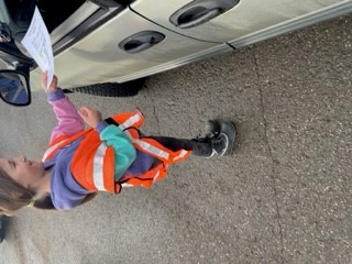 photo of child handing paper ticket to driver